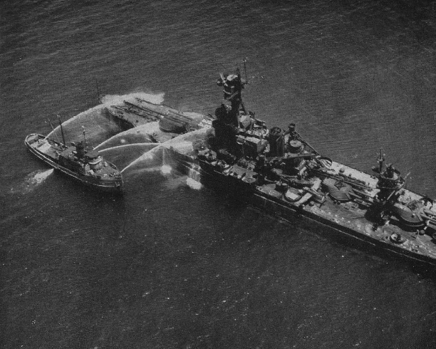 Crossroads_Baker_Hosedown.jpg - In a largely ineffective effort to wash off base surge contamination, a navy fireboat hoses down the battleship New York with radioactive lagoon water.