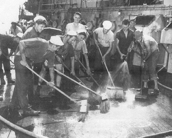 Crossroads_Baker_Scrubdown.jpg - Sailors scrubbing down the German cruiser Prinz Eugen with brushes, water, soap, and lye. Five months later, the ship was still too radioactive to permit repairs to a leak, and she sank.