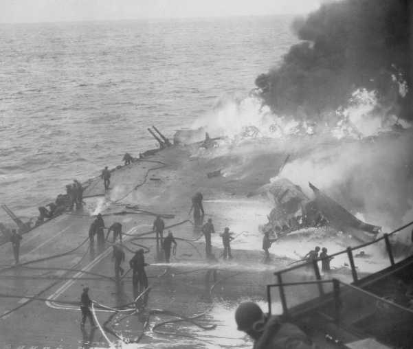 USS_Saratoga_Kamikaze_hit_21_February_1945.jpg - USS Saratoga hit by Kamikazes, 21 February 1945.